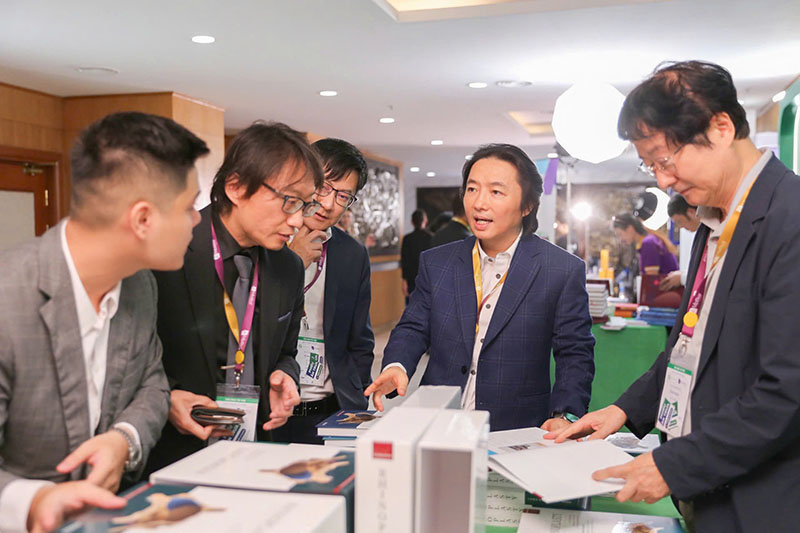 Dr. Richard Huy talks with professors at the conference